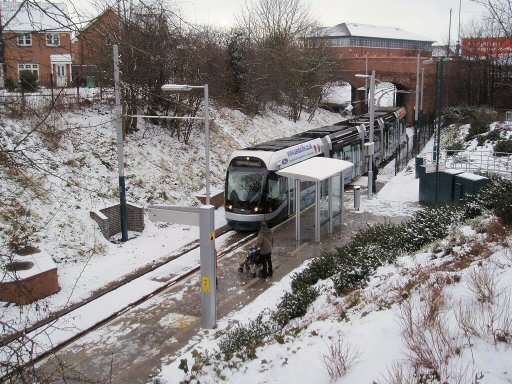 Nottingham Express Transit tram snow at Cinderhill stop